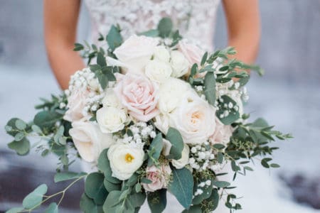 Closeup of bridal bouquet with pastel flowers and greenery