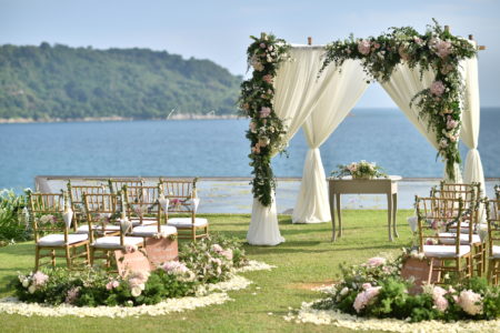Beautiful outdoor wedding ceremony near the water and mountains