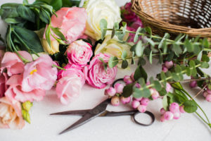 Pink flowers, basket, and scissors