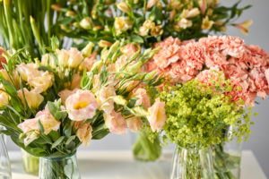 Variety of peach flowers and greens