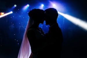 bride and groom in silhouette facing each other