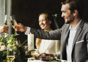 People Cling Wine Glasses on Wedding Reception at table