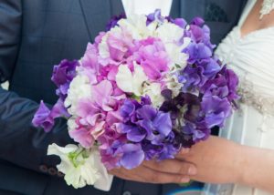 Bridal bouquet with pink, purple, and lavender sweet pea flowers