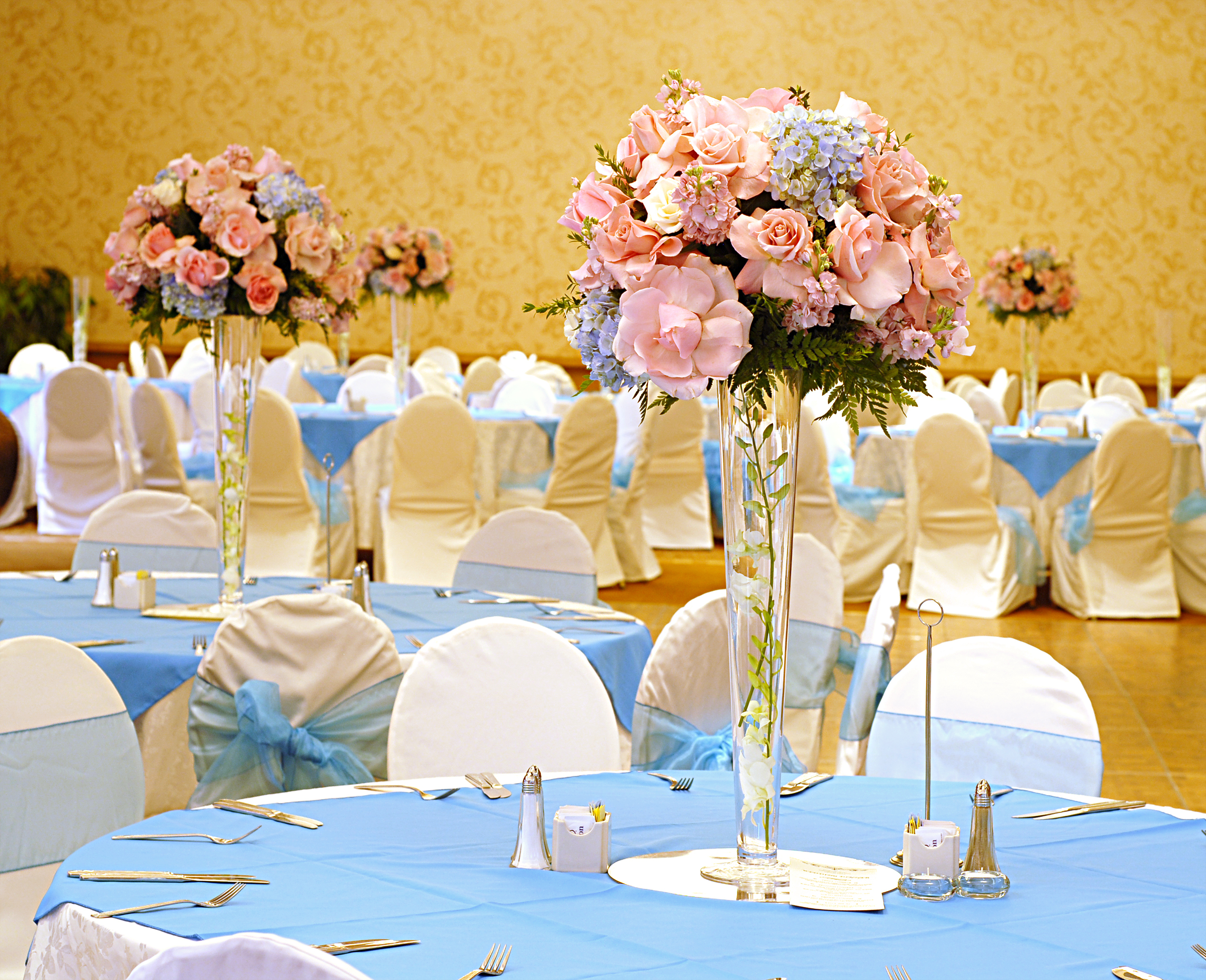 Baby blue and pastel pink flowers and decor for elegant gender reveal event