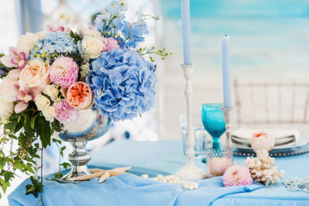 Beautiful decorated table set for wedding party. Wedding decorations with flowers