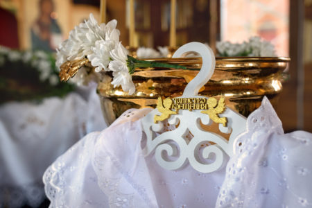 baptismal shirt hanging on the font ,sacrament baptism