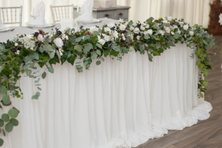 Wedding table. Flower Decoration Arrangement with Eucalyptus and white flowers. Rustic style.