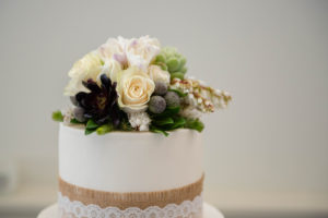 Collection of flowers on top of a wedding cake