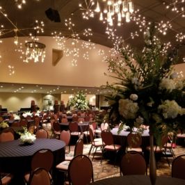 Reception hall with tall and short floral centerpieces