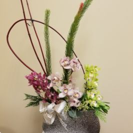 Centerpiece featuring green and pink orchids