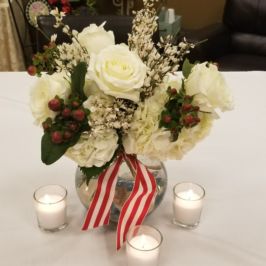 Centerpiece of white flowers and winter berries