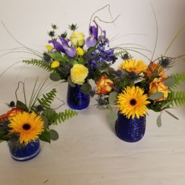 Bright yellow, orange and purple floral centerpieces