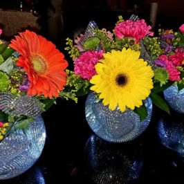 Bright floral centerpieces in blingy vases