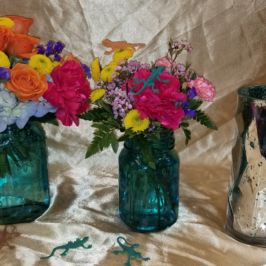 Bright floral centerpieces in turquoise vases