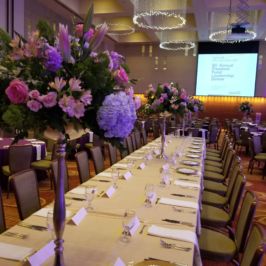 Tall floral centerpieces in a reception hall
