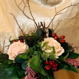 Winter arrangement with white roses and berries