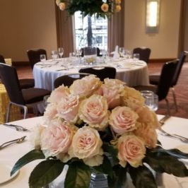 Centerpiece of pastel roses and greenery