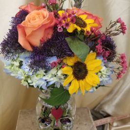 Bouquet of bright flowers in unique vase