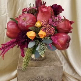 Arrangement with red flowers and apples