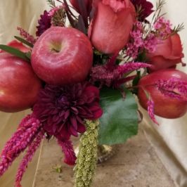Arrangement with red flowers and apples