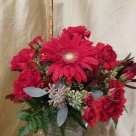 Cube arrangement of red flowers and greenery