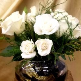 Arrangement of white roses and greenery