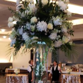 Tall centerpieces of white flowers and greenery
