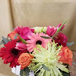 Cube arrangement of pink, peach and green flowers