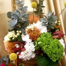 Centerpiece of white, green and orange flowers