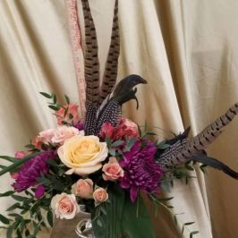 Bouquet of feathers and roses with greenery
