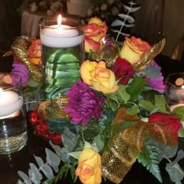 Centerpiece of bright flowers and floating candles