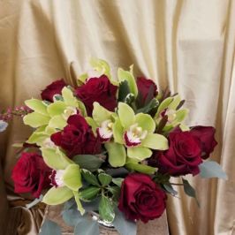 Centerpiece of red roses and green orchids