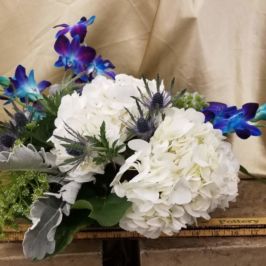 Arrangement of white and blue flowers and greenery