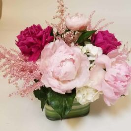 Cube vase of peonies in shades of pink