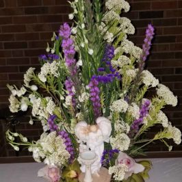 Sympathy arrangement of purple and white flowers