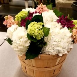 Basket of white, green and burgundy flowers