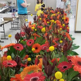 Long table of orange, red and yellow flowers