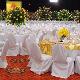 Reception hall setup with tall centerpieces