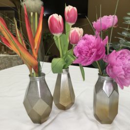 Bud vases of birds of paradise, tulips and peonies