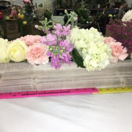 Long arrangement of pastel flowers