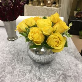 Yellow roses in mercury glass bowl vase