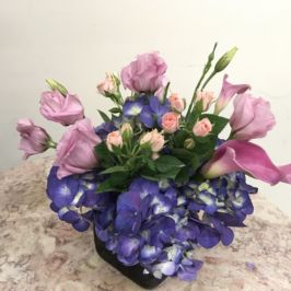 Cube arrangement of purple and pink flowers