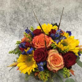 Arrangement of yellow, orange, red and purple flowers