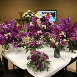 Arrangements of purple flowers in varying heights
