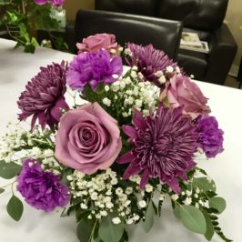 Arrangement of purple flowers and baby's breath